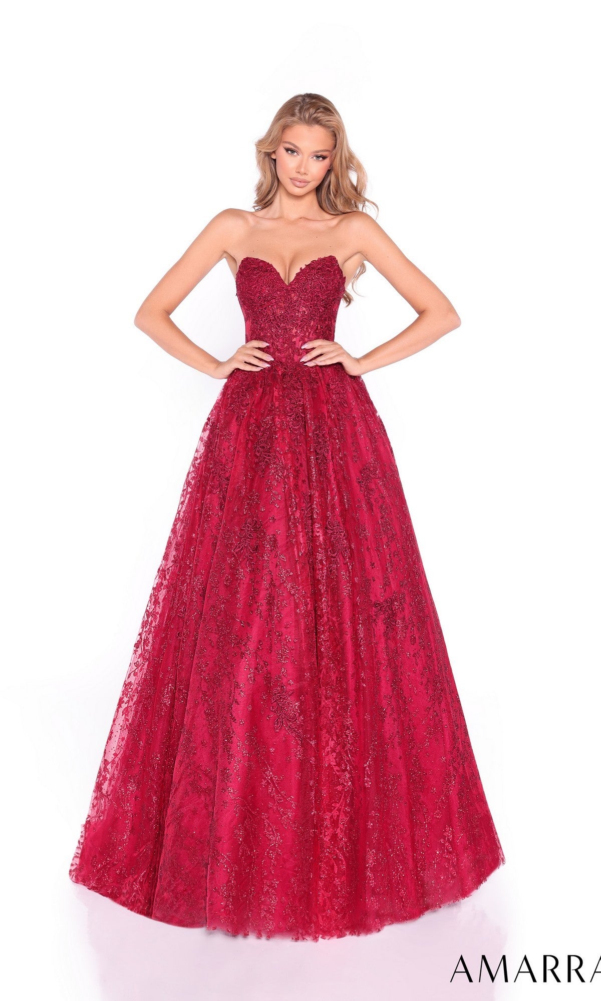 A woman models the Amarra 89427 long prom dress, featuring a strapless lace design with a sweetheart neckline, corset bodice, and floor-length skirt, standing against a white background.
